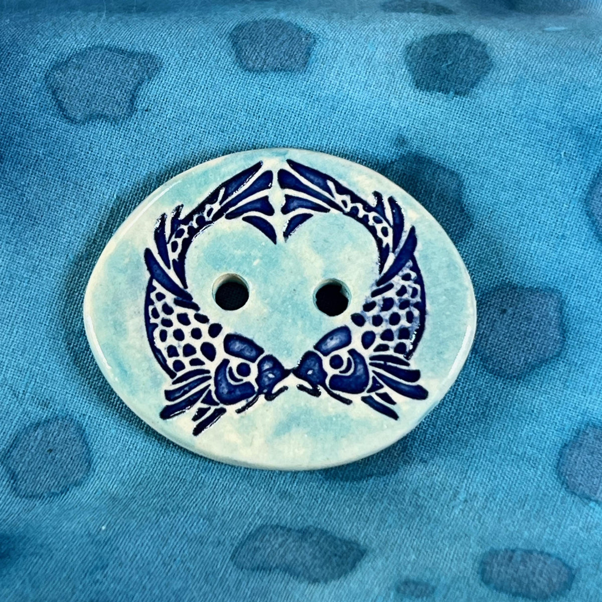 Two Koi Heart on Light Blue Oval Button