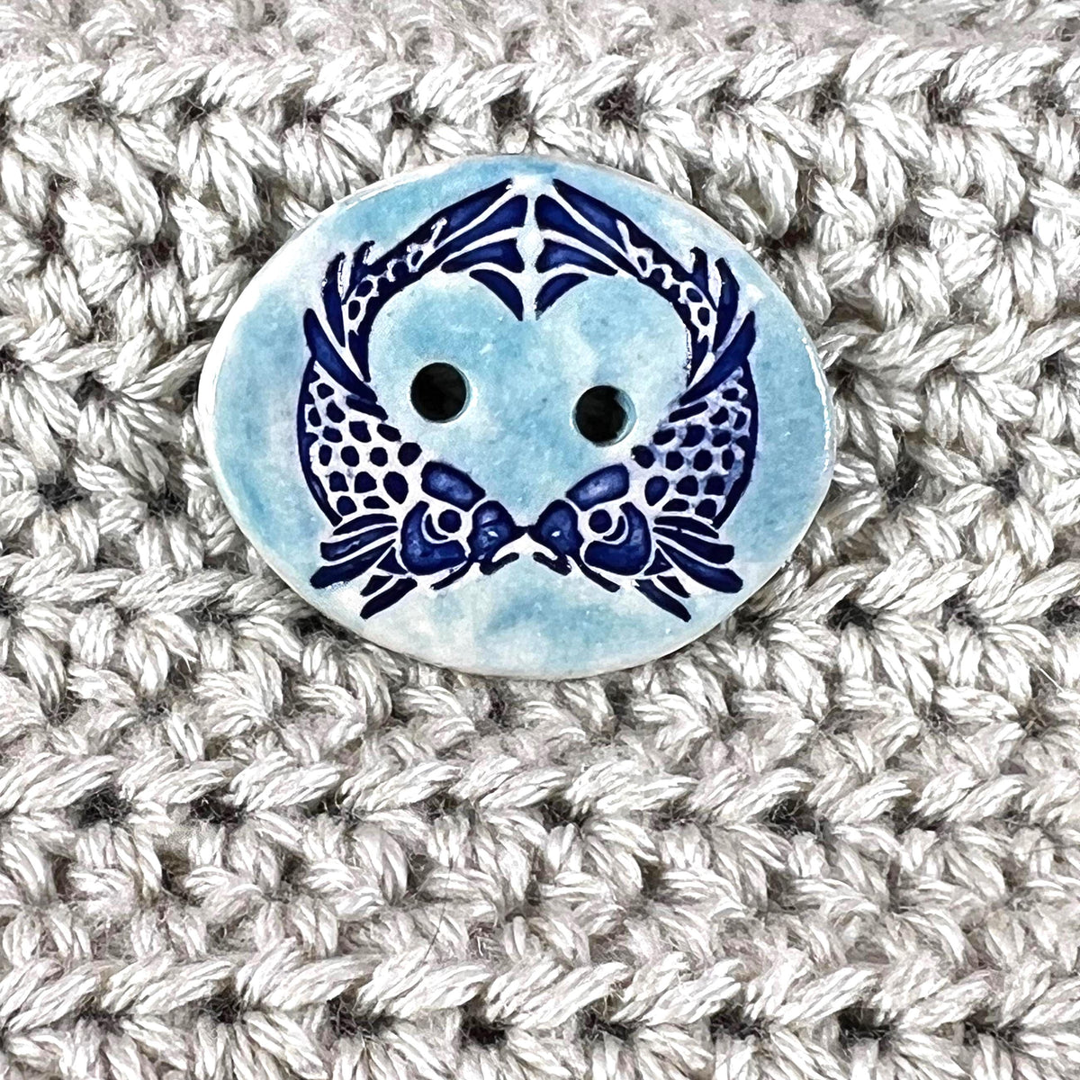 Two Koi Heart on Light Blue Oval Button