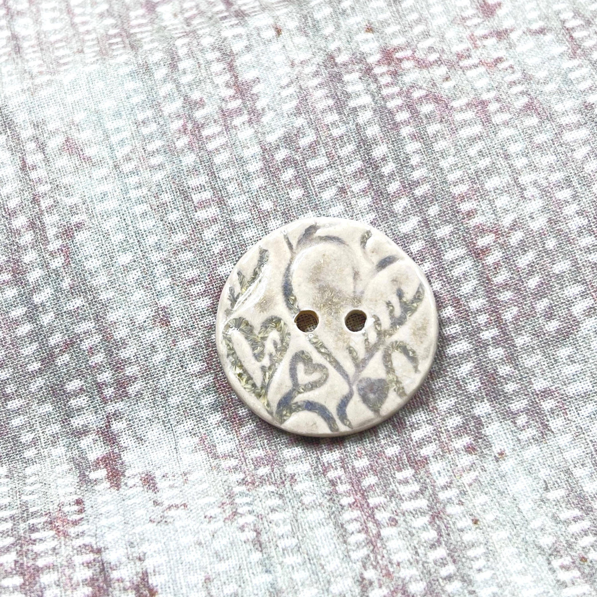 4 White Round Buttons with Light Gray Heart Pattern