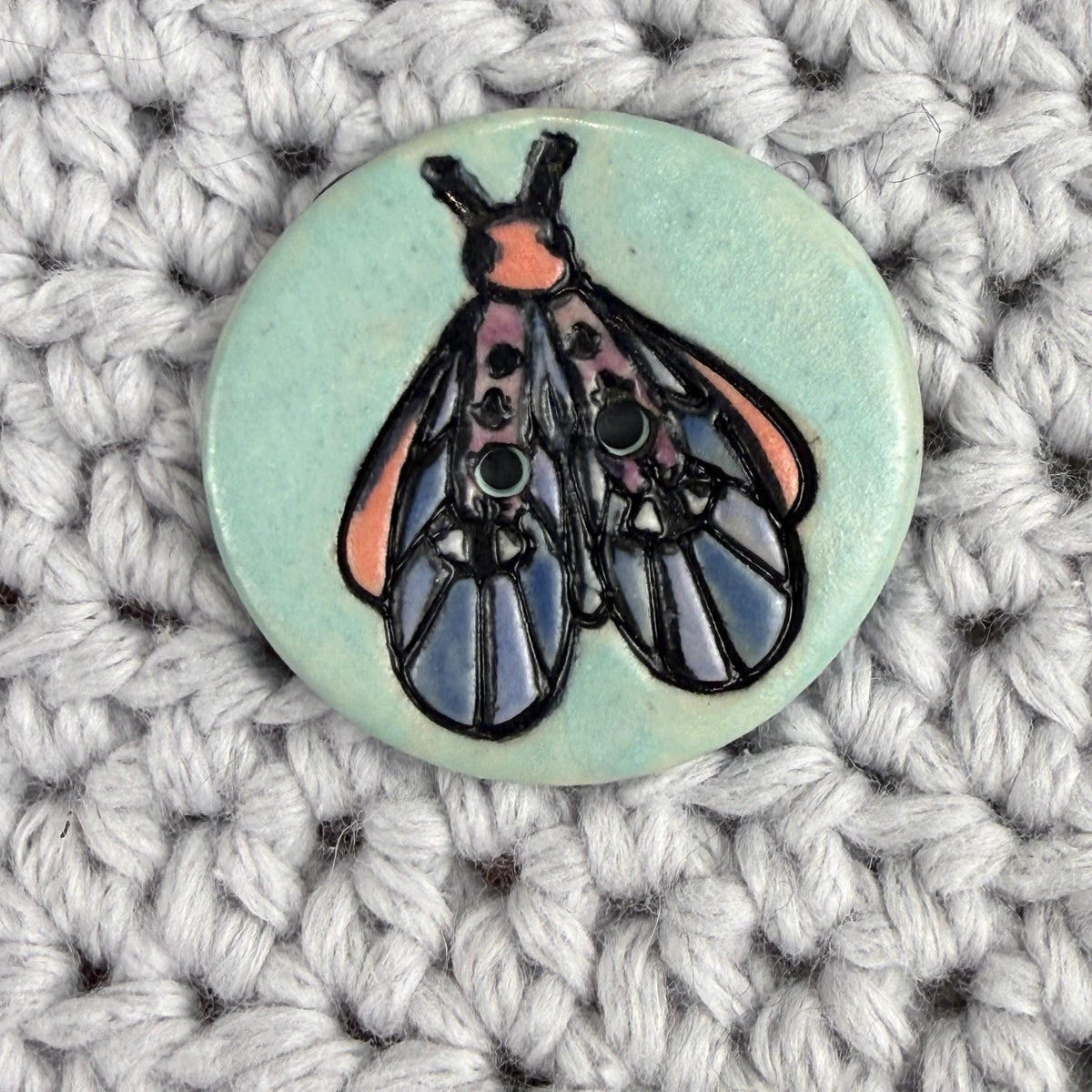 Blue Moth with Eyes on Aqua Blue Ceramic Button