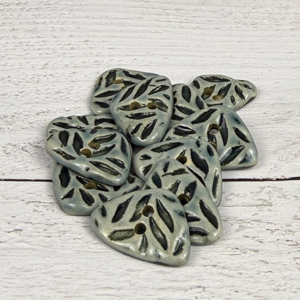 Small Triangular Shaped Buttons in Light Sage with Dark Sage Leaf Pattern